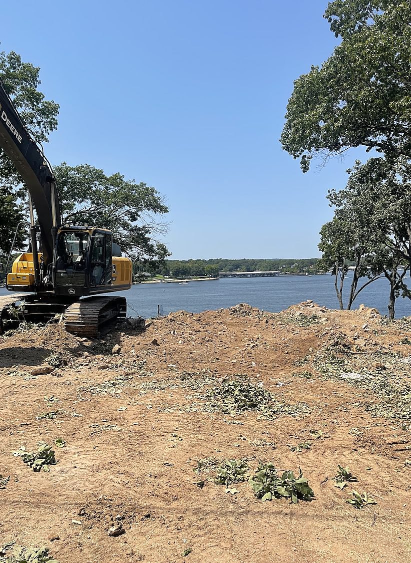 Tracked excavator regrading a lakeside property in northeast Oklahoma