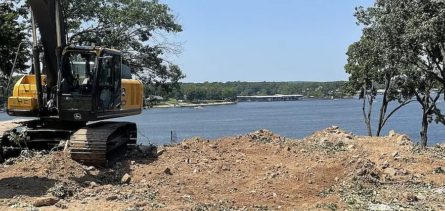 Tracked excavator regrading a lakeside property in northeast Oklahoma