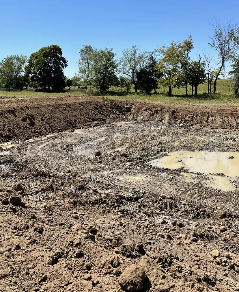 Pond basin dug out, with water standing in the bottom